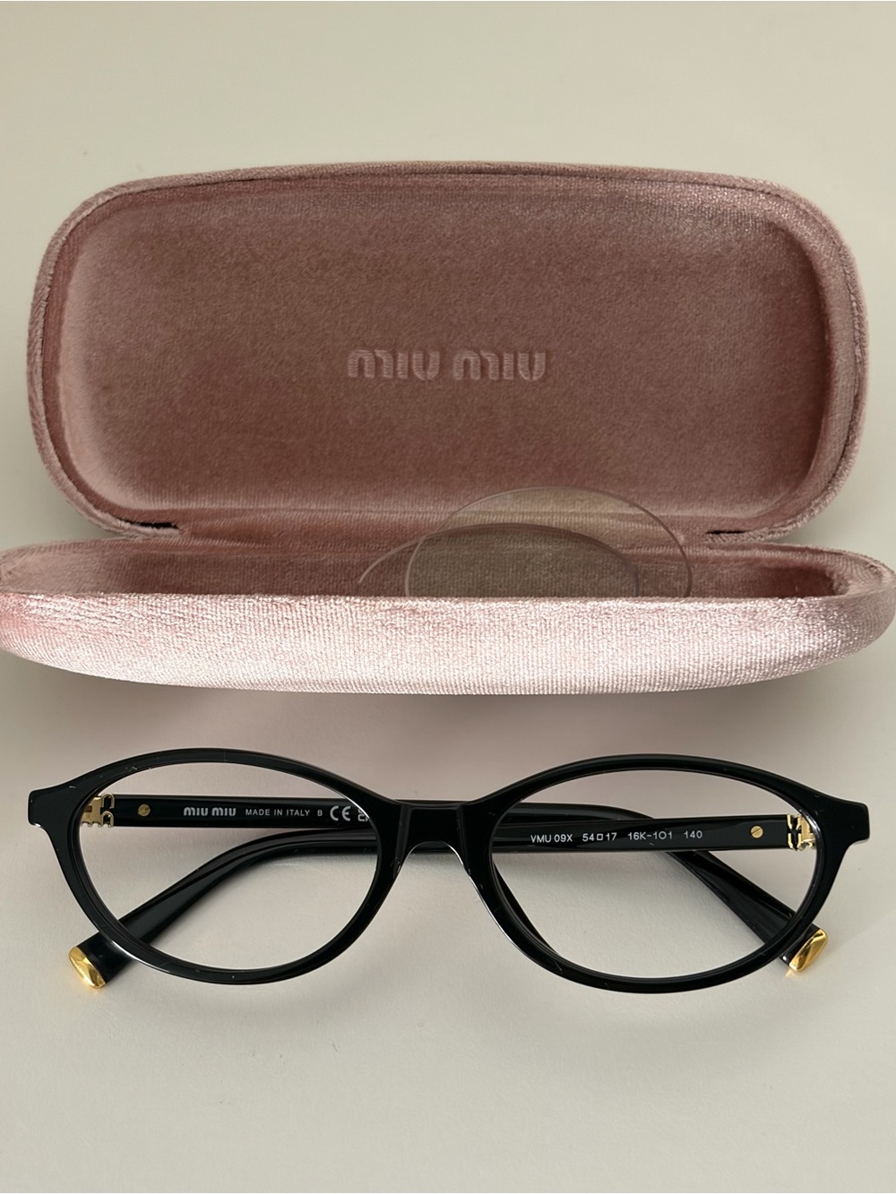 Miu Miu Black Round Eyeglasses with Gold Accents and Pink Velvet Case